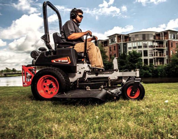 man driving bobcat zt3500 mower while cutting grass